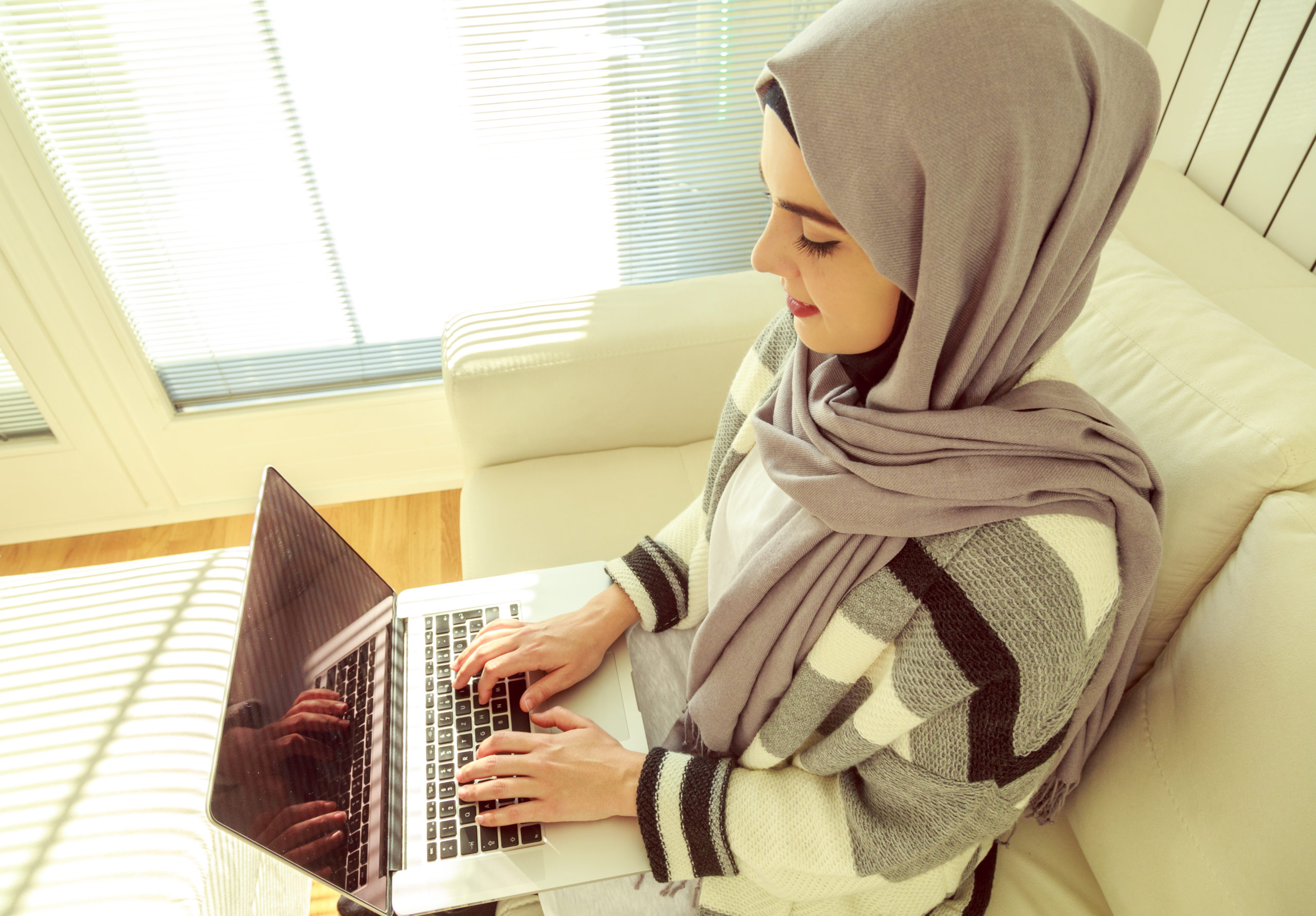 Muslim,Woman,Working,On,Laptop,,Overhead,Shot.