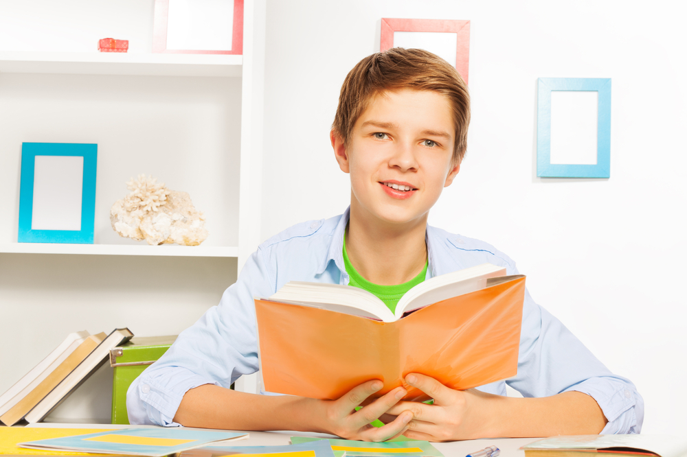Handsome,Young,Teen,Boy,Reading,Book,Doing,Homework,At,Home