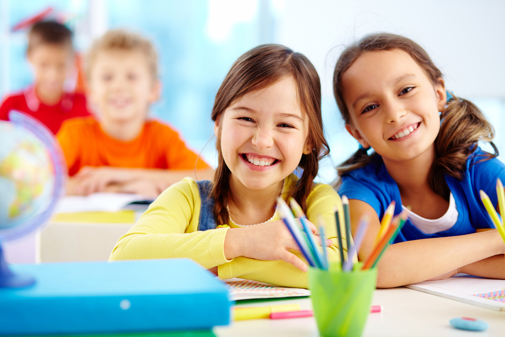 Portrait,Of,Two,Diligent,Girls,Looking,At,Camera,At,Workplace
